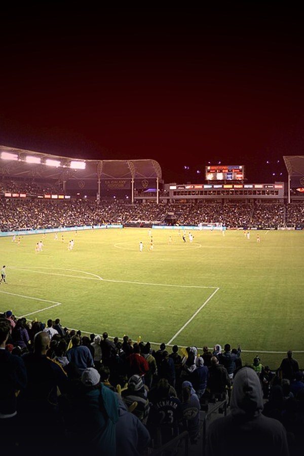 Floodlit football stadium seen from the stands — Pitch Side world football on KemoTV
