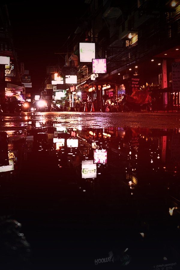 Rain-soaked neon street at night — Prairie Noir crime collection on KemoTV